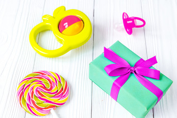 rainbow candy and gift box on wooden background