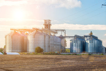 Agricultural Silos. Storage and drying of grains, wheat, corn, soy, sunflower against the blue sky...