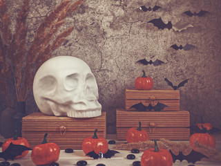 The figure in the form of a human skull is on a wooden box. Nearby are other caskets, small...