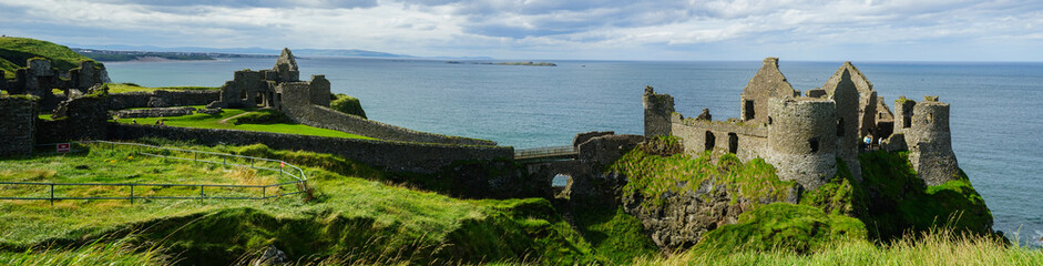 Fototapeta premium Panoramic view of Dunluce Castle above the cliffs, Antrim, Causeway Coastal Route, Northern Ireland