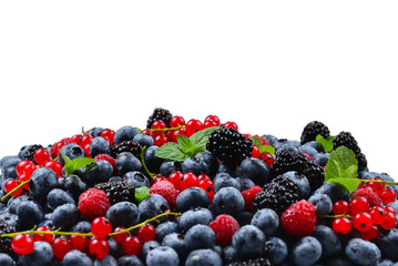 Blackberry, raspberry, blueberry,  red currant and mint background. Isolated on white. Copy space.