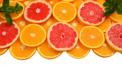 Slices of oranges and a grapefruits and mint isolated on white a background. 