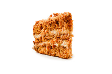 Peace of honey cake isolated on white background.