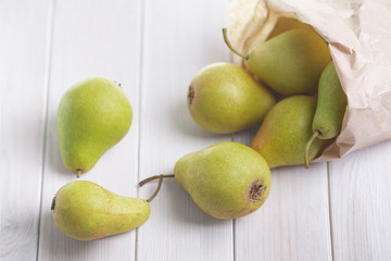 Fototapeta na wymiar Fresh pears in paper bag on white background.