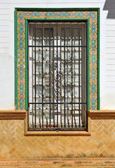 Beautiful window decorated with a tiles frame of an important house in Constantina,  picturesque village in the province of Seville Andalusia Spain
