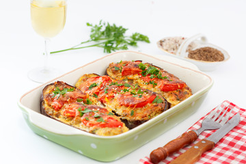 Stuffed eggplant from the oven. Baked eggplant or aubergine stuffed with vegetables, herbs and spices. Turkish or Greek  vegetarian food.