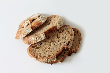 Sliced black bread, homemade rye bread on a white background. Copy space, healthy eating.