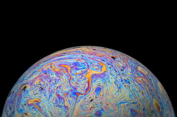 Abstract Soap bubble macro photo with black background look like planet