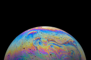 Abstract Soap bubble macro photo with black background look like planet
