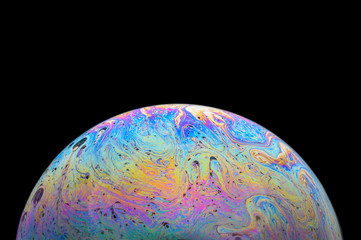Abstract Soap bubble macro photo with black background look like planet