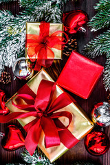 gifts boxes with fir branches on wooden background top view