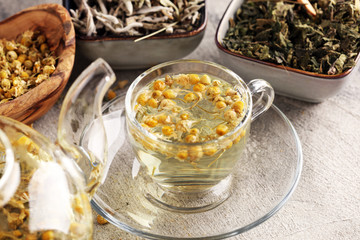 tea with Chamomile, sage and stinging nettle tea. Dried chamomile tea on table