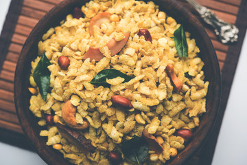 Jada Poha Namkeen Chivda / Thick Pohe Chiwda is a jar snack with a mix of sweet, salty and nuts flavours, served with tea. selective focus