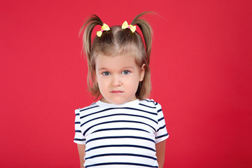 Cute little girl on red background