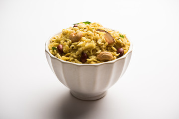 Jada Poha Namkeen Chivda / Thick Pohe Chiwda is a jar snack with a mix of sweet, salty and nuts flavours, served with tea. selective focus