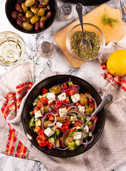 Fresh vegetables and goat cheese salad on the kitchen table