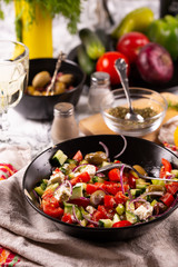 Fresh vegetables and goat cheese salad on the kitchen table