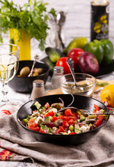 Fresh vegetables and goat cheese salad on the kitchen table
