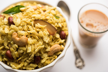 Jada Poha Namkeen Chivda / Thick Pohe Chiwda is a jar snack with a mix of sweet, salty and nuts flavours, served with tea. selective focus