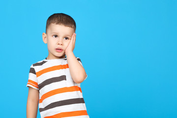 Cute little boy on blue background