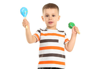 Cute little boy with mexican maracas isolated on white background