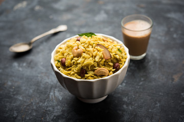 Jada Poha Namkeen Chivda / Thick Pohe Chiwda is a jar snack with a mix of sweet, salty and nuts flavours, served with tea. selective focus