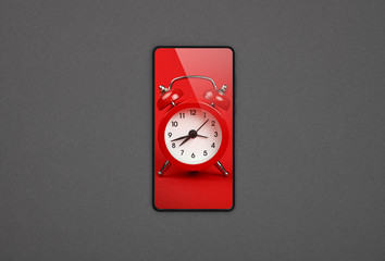 Smartphone with red alarm clock screen over grey