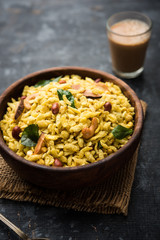Jada Poha Namkeen Chivda / Thick Pohe Chiwda is a jar snack with a mix of sweet, salty and nuts flavours, served with tea. selective focus