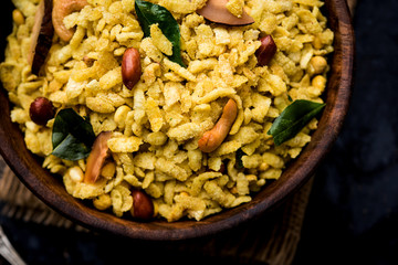 Jada Poha Namkeen Chivda / Thick Pohe Chiwda is a jar snack with a mix of sweet, salty and nuts flavours, served with tea. selective focus
