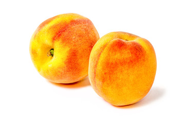 Two juicy peaches. Summer fruits. Harvest on the farm. Delicious igridient for juice. White background.
