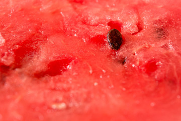 Red pulp and watermelon seeds close-up. Summer berry. Juicy red background.