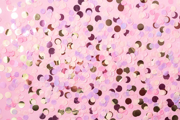 Fototapeta premium Pastel pink background with colorful round paper confetti. Holiday concept. Flat lay.