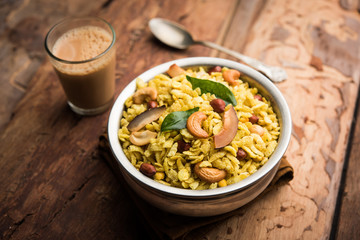 Jada Poha Namkeen Chivda / Thick Pohe Chiwda is a jar snack with a mix of sweet, salty and nuts flavours, served with tea. selective focus