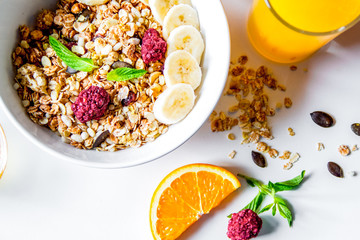 Breakfast with oatmeal and orange juice on white background