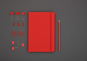 Neatly organized red stationery flat lay on grey