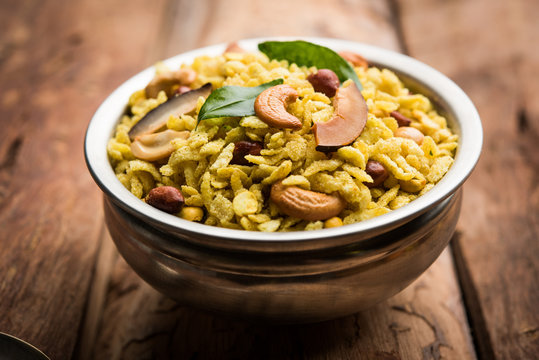 Jada Poha Namkeen Chivda / Thick Pohe Chiwda is a jar snack with a mix of sweet, salty and nuts flavours, served with tea. selective focus