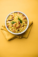 Jada Poha Namkeen Chivda / Thick Pohe Chiwda is a jar snack with a mix of sweet, salty and nuts flavours, served with tea. selective focus