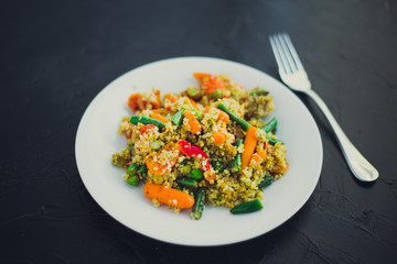 Traditional turkish food. couscous with vegetables, black background