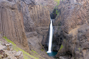 Long exposure photo of waterfall, view of the Hengifoss waterfall in Iceland, Europe.