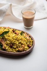 Jada Poha Namkeen Chivda / Thick Pohe Chiwda is a jar snack with a mix of sweet, salty and nuts flavours, served with tea. selective focus