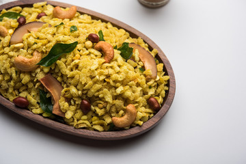 Jada Poha Namkeen Chivda / Thick Pohe Chiwda is a jar snack with a mix of sweet, salty and nuts flavours, served with tea. selective focus