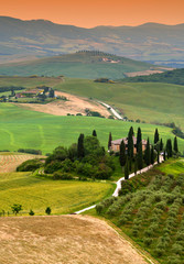 Famous Podere Belvedere Villa Belvedere in summer season, in the heart of the Tuscany at sunset. Val d'Orcia.