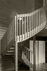 internal wooden spiral staircase in a yellow monochrome tonality