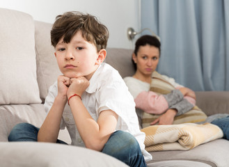 Fototapeta premium Displeased boy after discord with mother