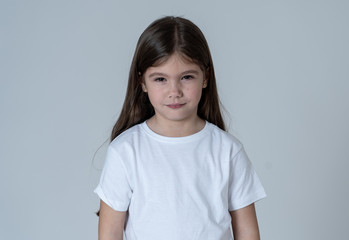 Pretty little girl with a angry facial expression looking mad at the camera. Children emotions