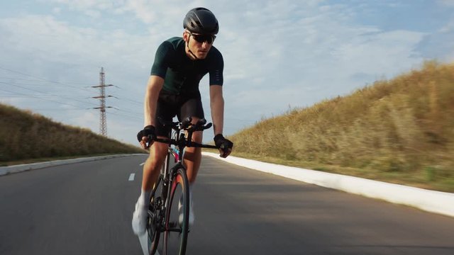 Sports athlete man biking with high intensity on highway