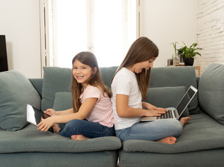 Two pretty sisters having fun together playing and surfing on th