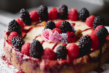 fancy cheesecake with berries and flowers 