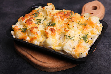 Baked cauliflower on wooden board