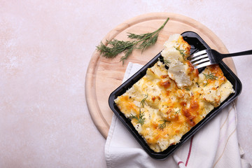 Baked cauliflower on wooden cutting board